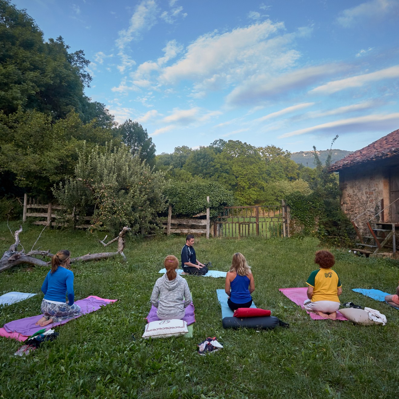 a group of people sitting in a yard