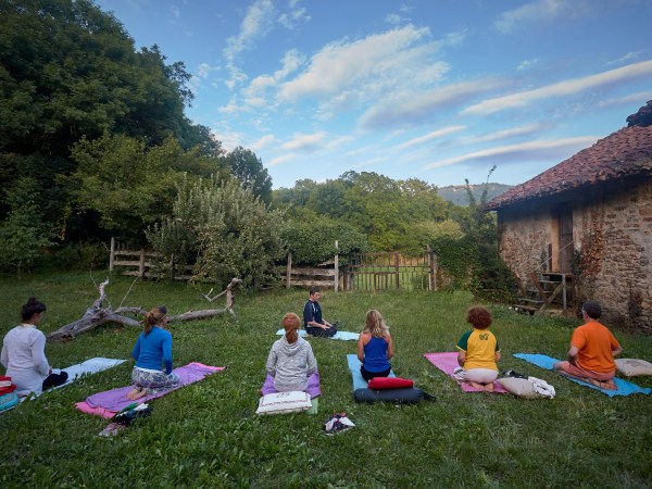 a group of people sitting in a yard