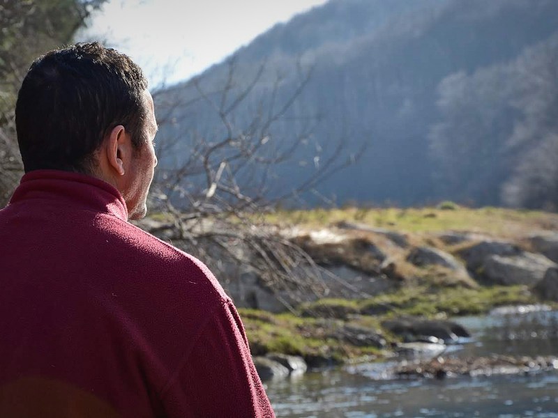 a man standing in front of a mountain