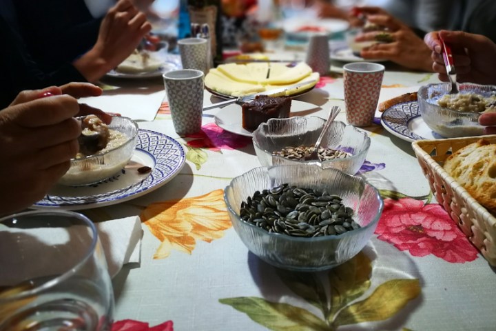 a person sitting at a table with a cake