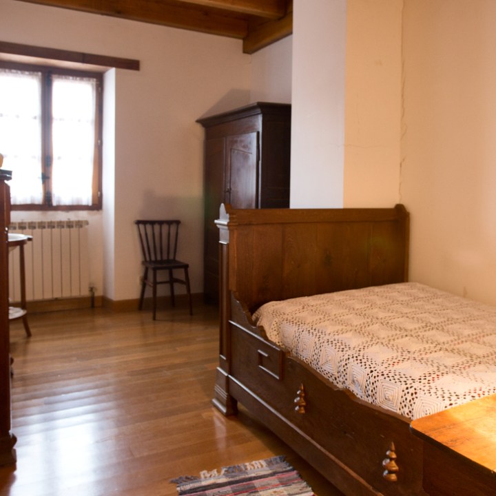 a bedroom with a bed and a table in a room