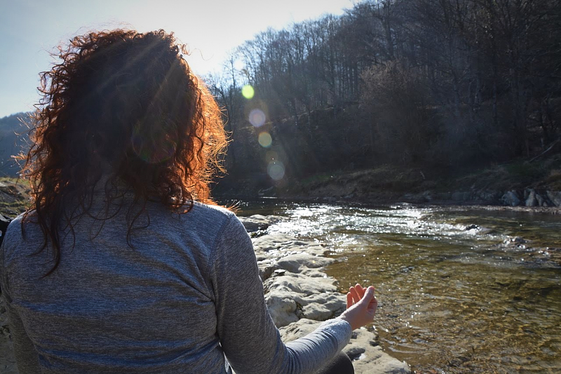 a person standing in front of a body of water
