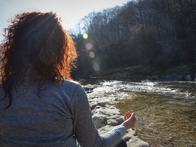 a person standing in front of a body of water