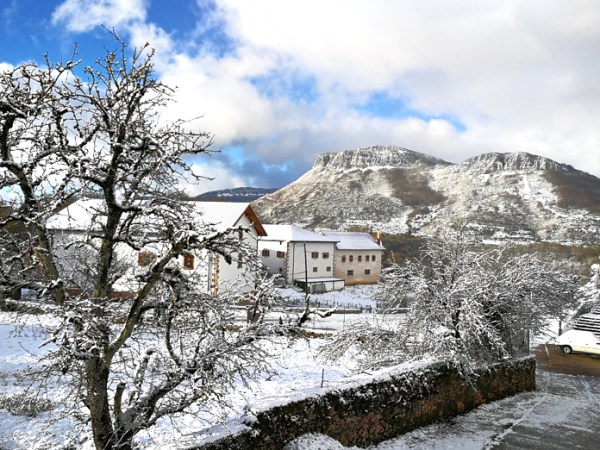 a man riding a snowboard down a snow covered mountain