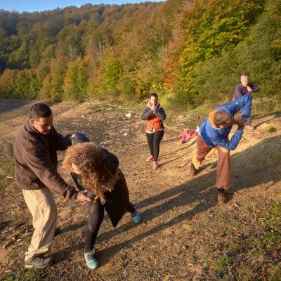 Utthita Parsvakonasana Asanasa group of people walking down a dirt road