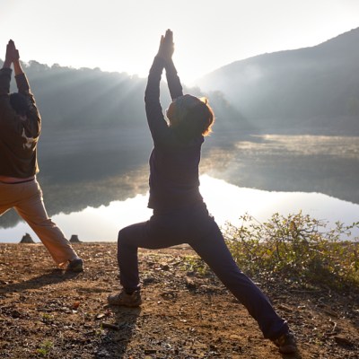 a person jumping into the air to catch a frisbee