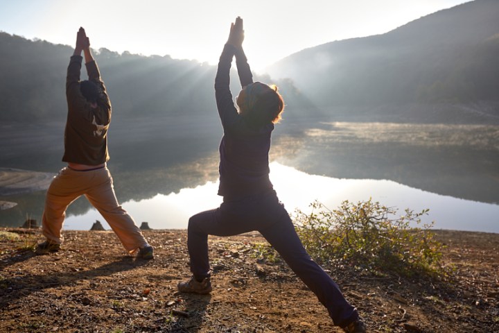 a person jumping into the air to catch a frisbee