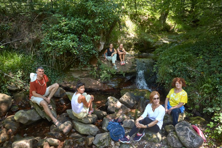 a group of people sitting on a rock