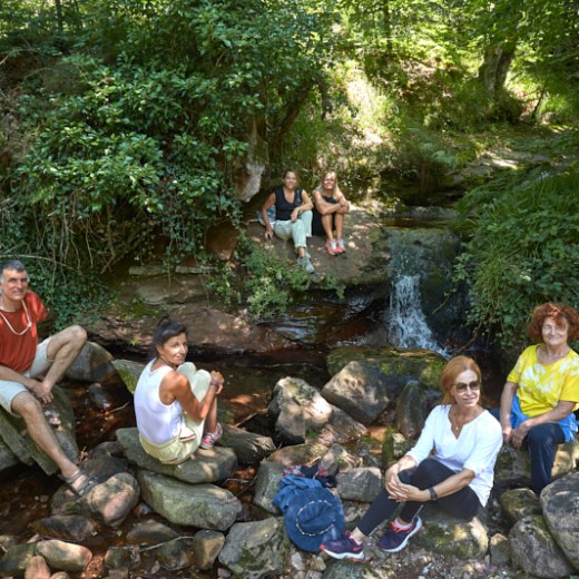 a group of people sitting on a rock