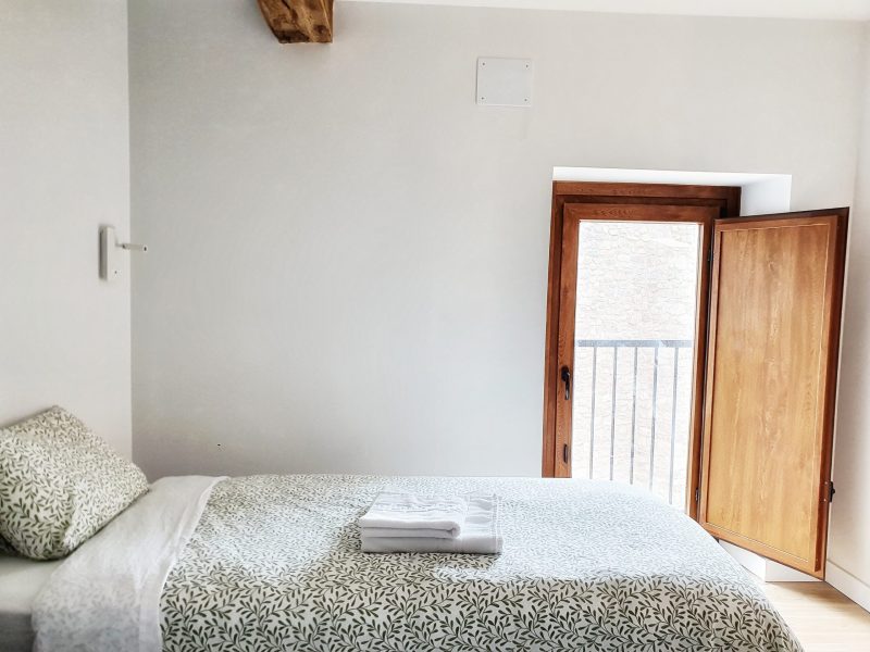 a bedroom with a wooden door