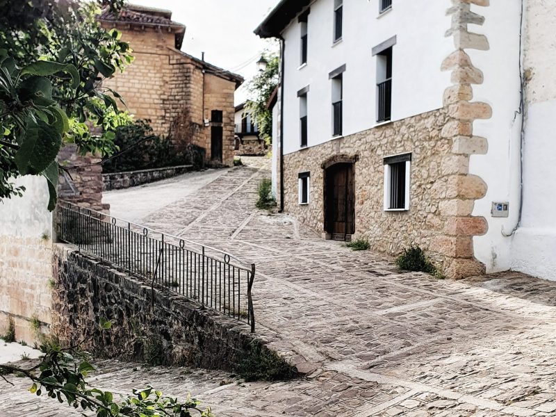 a path leading to a brick building