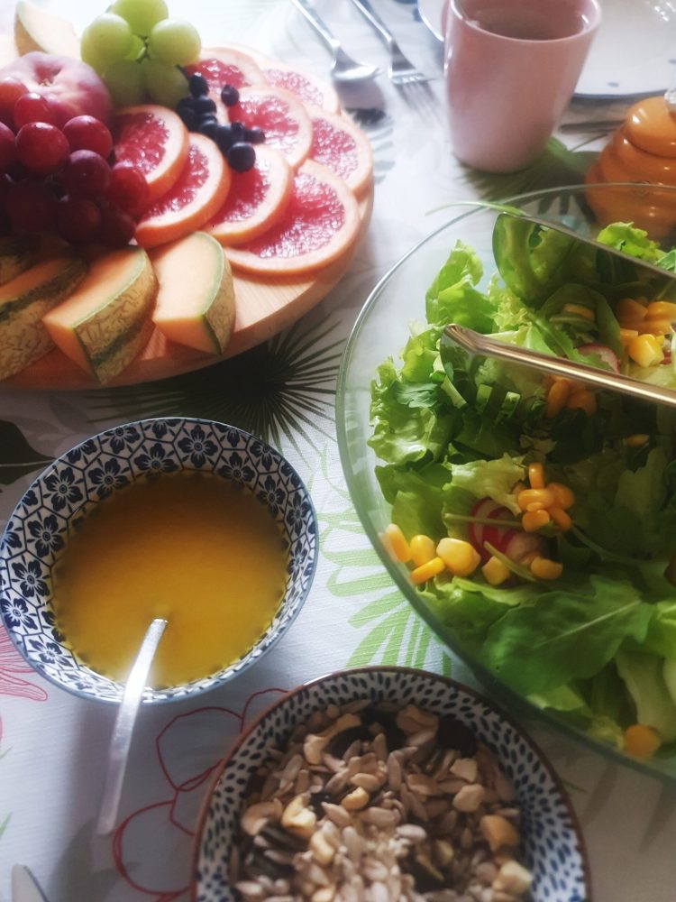 a bowl of fruit on a plate on a table