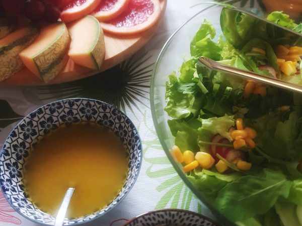 a bowl of fruit on a plate on a table