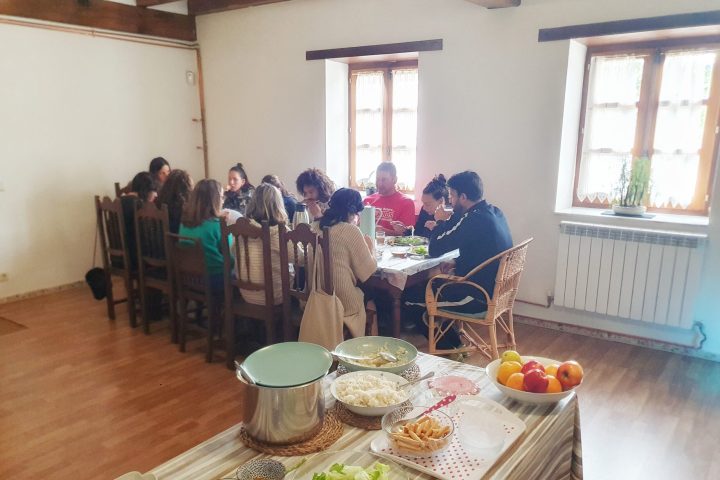 a group of people sitting at a table with food