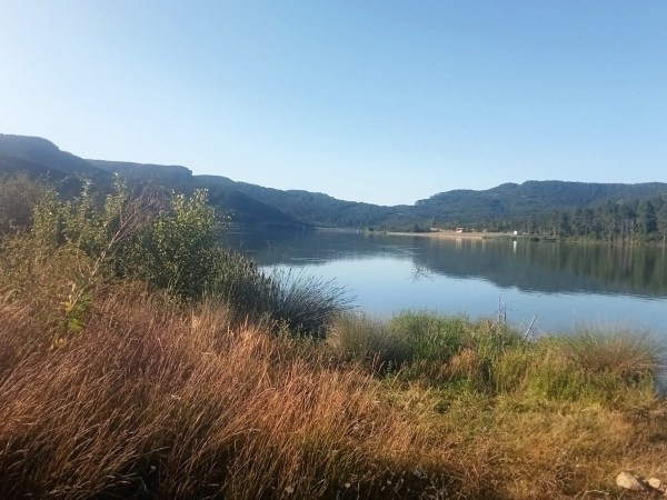 a body of water with a mountain in the background