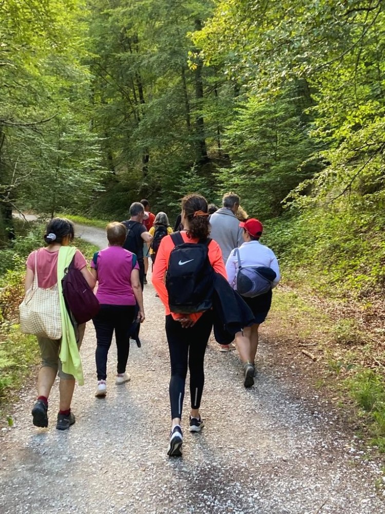 a group of people walking down a dirt road