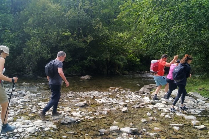 a group of people standing on a rock