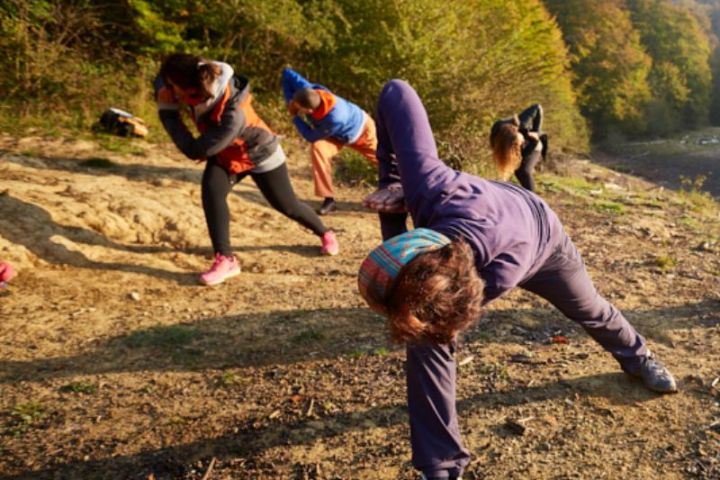 Grupo de personas practicando posturas de yoga en retiro de yoga en Pirineos