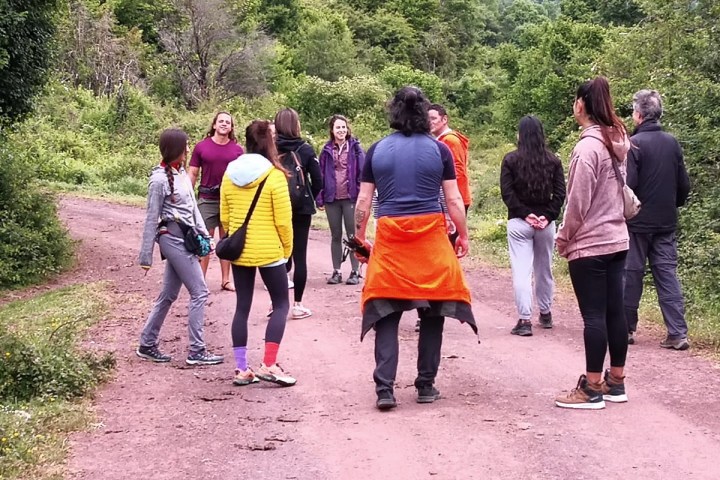 a group of people walking down a dirt road