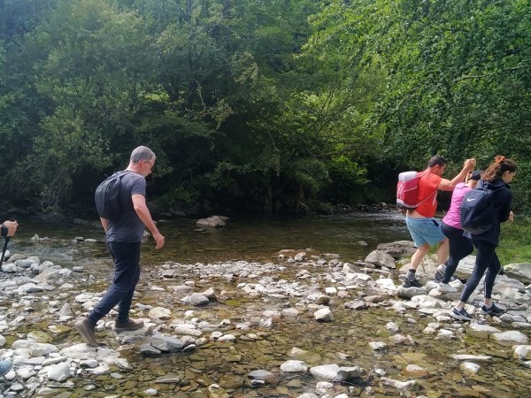a group of people standing on a rock