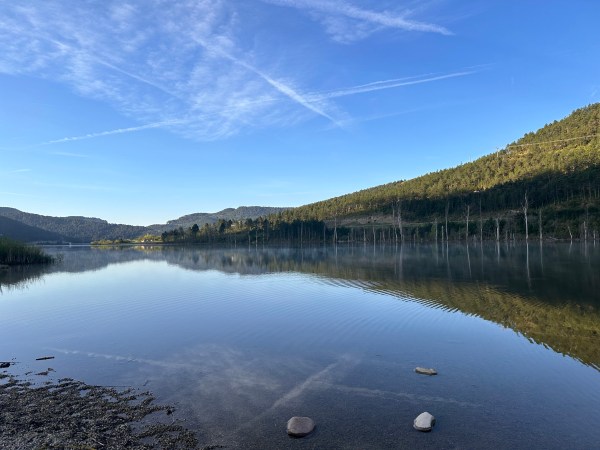a large body of water with a mountain in the background