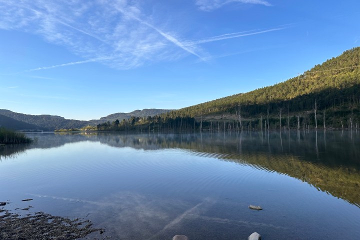 a large body of water with a mountain in the background