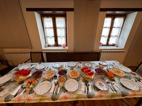 a plate of food on a table next to a window