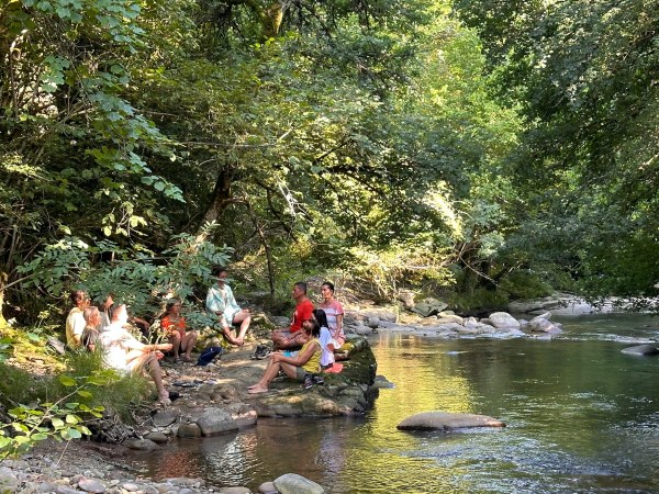 a group of people riding on top of a river